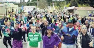  ?? PHOTOS: SUPPLIED ?? Safety first, but fun too . . . Hundreds of Maniototo residents run and dance with video star Julian Dennison (centre, front) in Naseby, in Air New Zealand’s latest safety video.