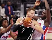  ?? CARLOS OSORIO — THE ASSOCIATED PRESS ?? Brooklyn Nets forward Blake Griffin (2) is defended by Detroit Pistons forward Sekou Doumbouya during the first half of Friday’s game in Detroit.