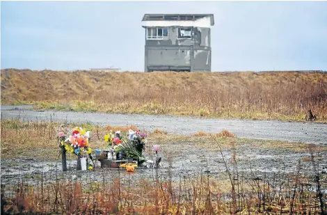  ?? Picture: JIJI PRESS / JIJI PRESS / AFP ?? FLORAL TRIBUTE: Flowers to honour those who died in a tsunami in Namie, Fukushima, Japan, placed on a site on the eighth anniversar­y of the disaster