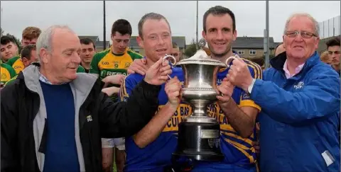  ??  ?? Brendan Browne, Robert Browne, team captain Jamie Cooney and Mick Duffin with the Duffin-Browne Memorial Cup.