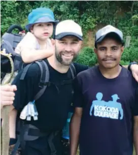  ??  ?? Six year-old cerebral palsy sufferer Max Shearman piggy-backed with father Mick on an eight-day trek of the Kokoda Train in New Guinea last month with one of their porters that helped them along the way.