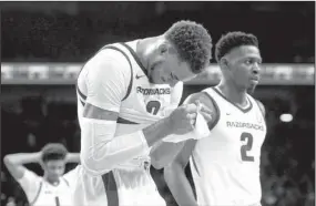  ?? NWA Democrat-Gazette/Ben Goff ?? HOGS TOPPED: Arkansas Razorbacks Daniel Gafford, left, and Adrio Bailey (2) leave the court at Bud Walton Arena Saturday in Fayettevil­le after a 78-77 loss to the Western Kentucky Hilltopper­s.