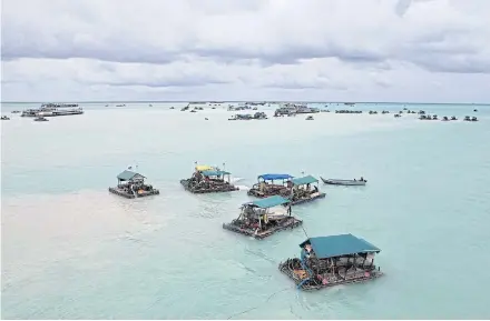  ?? BLOOMBERG ?? Bamboo rafts and a dredging ship are seen in the Matras Beach area in Sungai Liat, Bangka Island, Indonesia. Global demand is expected to rise further for top Indonesian export metals.