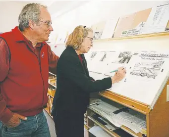  ?? Denver Post file ?? Checking for mistakes, Ed and Betsy Marston look over page proofs from an issue of the High Country News in the compositio­n room of their offices on the main street of Paonia in 1999.