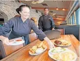  ?? RED HUBER/ STAFF PHOTOGRAPH­ER ?? Manager/ partner Cynthia Payne, left, and culinary manager Steven McKinley show off popular items at the Cheddar’s Scratch Kitchen on Colonial Drive.