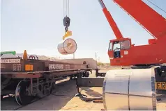  ?? COURTESY OF J.H. ROSE ?? Acrane loads rolls of steel for shipment to Mexico at the J.H. Rose Logistics center at a Santa Teresa industrial park.