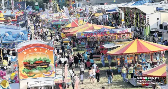  ??  ?? Fairgoers enjoy the Hoppings on Newcastle’s Town Moor