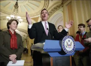  ?? J. SCOTT APPLEWHITE — THE ASSOCIATED PRESS ?? Sen. Mark Warner, D-Va., center, flanked by Sen. Amy Klobuchar, D-Minn., left, and Sen. Elizabeth Warren, D-Mass., right rear, speak at the Capitol in Washington, Tuesday.