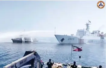  ?? — AFP photo ?? File photo of a frame grab taken from video footage showing a Chinese Coast Guard ship (right) using a water cannon on a Philippine Bureau of Fisheries and Aquatic Resources (BFAR) vessel near Scarboroug­h Shoal in the disputed South China Sea.