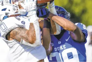  ?? JIM DEDMON/ASSOCIATED PRESS ?? North Carolina wide receiver Emery Simmons makes a touchdown catch against Duke cornerback Jeremiah Lewis during the first half of the Tar Heels’ 56-24 victory Saturday.