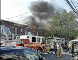  ?? FILE PHOTO ?? Fire equipment fills East State Street in Hamilton as firefighte­rs battle a multi-alarm fire in the 1700 block of East State Street Monday, June 8, 2015.