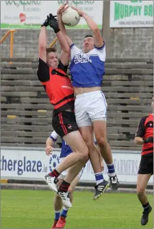  ??  ?? Ballyhogue’s Syl Byrne competes in the air with Bannow-Ballymitty’s Conor Furlong during the IFC clash at Wexford Park.