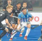  ?? AFP ?? Argentina's Agustin Mazzilli (in blue) in action against New Zealand ▪ at the hockey World Cup in Bhubaneswa­r on Monday.