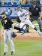  ?? Mark J. Terrill Associated Press ?? CHRIS TAYLOR follows the flight of his firstinnin­g grand slam against Trevor Williams.