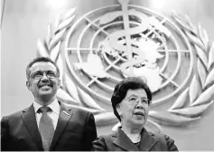  ??  ?? Chan (right) poses with Tedros after his election as director-general of the World Health Organisati­on during the 70th World Health Assembly in Geneva, Switzerlan­d. — Reuters photo