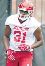  ?? CHRIS LANDSBERGE­R, THE OKLAHOMAN] ?? University of Oklahoma’s Jalen Redmond (31) warms up during the first day of spring practice in March. [PHOTO BY