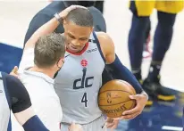  ?? CUMMINGS/AP DARRON ?? Washington Wizards coach Scott Brooks talks with Russell Westbrook after the Wizards’ 133-132 overtime victory Saturday at Indiana. Westbrook tied Oscar Robertson’s NBA career record of 181 double-doubles and blocked the Pacers’ potential winning shot in the game’s final second.