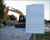  ?? KRISTINA WEBB / THE PALM BEACH POST ?? A notice of demolition is posted in front of a bulldozer on the Wellington site, which was declared unsafe for residents because of dangerous levels of mold.