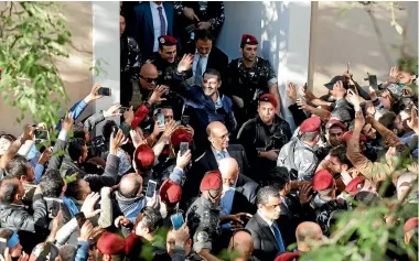 ?? PHOTO: REUTERS ?? Saad al-Hariri, who suspended his decision to resign as prime minister, gestures to his supporters at his home in Beirut, Lebanon.