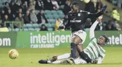  ??  ?? 0 Dedryck Boyata challenges Dundee’s Roarie Deacon, which leads to the ball hitting the post and rolling along the goal-line.