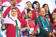  ??  ?? Indian student Asmita Pal (front second from left) and her teammates with their trophies during the Malaysia event.