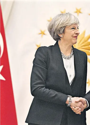  ??  ?? Left, Theresa May (centre) visits the mausoleum of Kemal Ataturk in Ankara. Right, with Recep Tayyip Erdogan at the presidenti­al palace