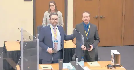  ?? COURT TV ?? In an image from video, defense attorney Eric Nelson, left, former police Officer Derek Chauvin and defense assistant Amy Voss introduce themselves to potential jurors last week in Minneapoli­s. Chauvin is charged in the death of George Floyd.