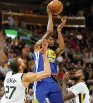  ?? THE ASSOCIATED PRESS ?? Golden State Warriors forward Kevin Durant, center, attempts to pass over Utah Jazz center Rudy Gobert, left, and Utah Jazz forward Royce O’Neale, right, in the first half of an NBA basketball game Tuesday in Salt Lake City.