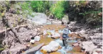  ?? COURTESY OF NEW MEXICO DEPARTMENT OF GAME AND FISH ?? New Mexico Game and Fish biologist Laurence D’Alessandro works his way through Whitewater Creek in May 2015, while looking for fish that might have survived wildfires that ravaged the area a few years earlier.