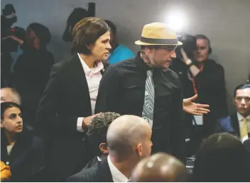  ?? DARRYL DYCK/THE CANADIAN PRESS ?? Will George of the Tsleil-Waututh First Nation is escorted out of the room after he called Prime Minister Justin Trudeau a liar and a weak leader during a Liberal fundraiser on Wednesday.