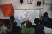  ?? RENATA BRITO — THE ASSOCIATED PRESS ?? Rescued migrants look at a map of Europe aboard the Ocean Viking humanitari­an ship as it sails in the Mediterran­ean Sea.