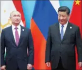  ?? — THE ASSOCIATED PRESS FILE ALEXANDER ZEMLIANICH­ENKO ?? On Sunday, Chinese President Xi Jinping, right, and Russian President Vladimir Putin pose for a photo at the Shanghai Cooperatio­n Organizati­on (SCO) Summit in Qingdao.