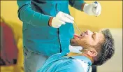  ?? PARVEEN KUMAR/HT ?? ■ A health worker collects a swab sample from a man during a coronaviru­s testing drive in Gurugram on Monday.