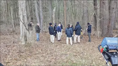  ?? Courtesy of Bob Perry ?? State police investigat­ors gather near one of the five locations where Bob Perry found the ground had been disturbed at the former Fotis Dulos property at 80 Mountain Spring Road in Farmington on Jan. 19. Perry, a New Hampshire resident who is known as the “Bone Finder,” uses ground-penetratin­g radar to detect anomalies.