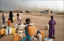  ?? TYLER HICKS / THE NEW YORK TIMES ?? People gather at a water collection point in Bani Hassan, Yemen. The biggest challenge in 2019 will be the three-year old conflict in Yemen, which has driven millions toward famine, the United Nations reports.