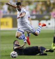  ?? MICHAEL PEREZ — THE ASSOCIATED PRESS ?? Montreal Impact’s Daniel Lovitz leaps to avoid the tackle of the Union’s Alejandro Bedoya during the first half Saturday.