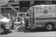  ?? AP/JACOB PEARSON ?? First responders assist one of the victims of a car crash Thursday at Times Square in New York.