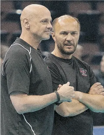  ?? GREG SOUTHAM/EDMONTON JOURNAL ?? Canada men’s volleyball coach Glenn Hoag, left, talks to assistant coach Terry Danyluk during Thursday’s practice at Rexall Place.