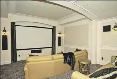  ??  ?? Above, imagine relaxing with a movie in your own theatre room. It was designed to feel like an old Italian theatre, with couches to give a refined feel to the space. Below, one of the secondary bedrooms in the house, which contains a total of 8,644...