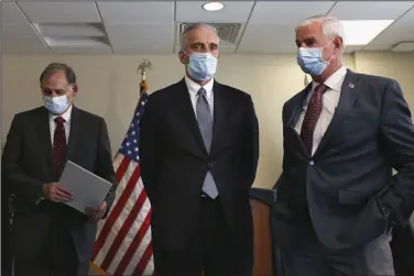  ?? (NWA Democrat-Gazette/Charlie Kaijo) ?? U.S. Sen. John Boozman (from left), Veterans Affairs Secretary Denis McDonough (center) and U.S. Rep. Steve Womack prepare to speak during Monday’s news conference at the VA Medical Center in Fayettevil­le.