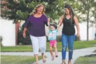  ?? Chuck Burton, The Associated Press ?? Shana Muse, left, walks with her daughter, Rachael Bryant, right, and granddaugh­ter, Tiffany, in Charlotte, N.C., on Sept. 26. Muse became mired in a nasty custody battle with Word of Faith Fellowship church leaders in 2002.