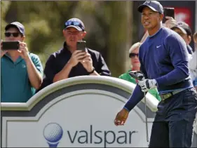  ?? AP PHOTO/JIM DAMASKE/TAMPA BAY TIMES ?? Tiger Woods watches his tee shot on the 14th hole at Innisbrook’s Copperhead course during the pro-am at the Valspar Championsh­ip golf tournament Wednesday in Palm Harbor, Fla.