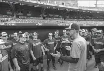  ?? The Associated Press ?? OMAHA STAKES: Oregon State baseball coach Pat Casey addresses his players in the dugout before team practice Friday in Omaha, Neb. on the eve of the College World Series, At 54-4, the Beavers enter the CWS with the fewest losses of any team since 1982.
