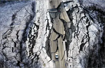  ?? MARC LESTER / ANCHORAGE DAILY NEWS ?? Vine Road, south ofWasilla, Alaska, is damaged after two earthquake­s Friday. The strongest quakemeasu­red at 7.0 magnitude.