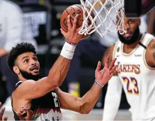  ?? Mark J. Terrill / Associated Press ?? Nuggets point guard Jamal Murray had 28 points, 12 assists and eight rebounds in a must-win Game 3.