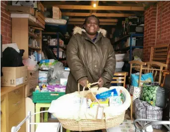 ?? Picture: Natalie Burton ?? BASKET OF GOODS: Josimah Baby
Bank’s founder Buki Adedoyin-Benson, with a newborn bundle assembled from new and donated items