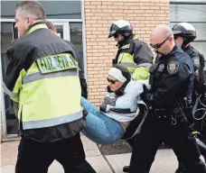  ?? SPENCER PLATT, GETTY IMAGES ?? Police arrest a protester outside a New Jersey detention center amid a rally denouncing President Trump’s deportatio­n policy.