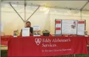  ??  ?? Andrew DeLollo, a grant manager with Eddy Alzheimer’s Services, sits behind his informatio­n table Friday at the fair.