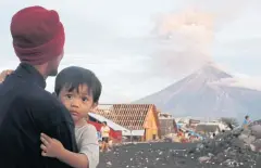  ?? EPA ?? Villagers look on as Mt Mayon erupts anew near Legazpi city, Albay province, Philippine­s yesterday.