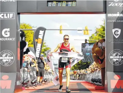  ?? STAFF PHOTOS BY ERIN O. SMITH ?? Cody Beals crosses the Ironman finish line Sunday. Beals has competed in two Ironman events and has placed first in both.